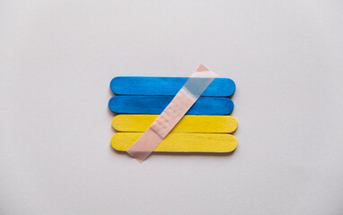 medical plaster on the flag of ukraine top view.  Defense of Ukraine