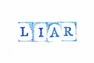 Blue color ink rubber stamp in word liar on white paper background