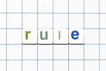 Colorful tile letter in word rule on white grid background