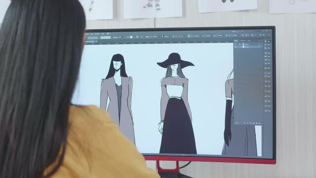 Over The Shoulder View Of A Female Designer Designing Clothes On A Desktop In The Studio. Dress Production Procedure Concept. Cyber Games Clothing And Designing
