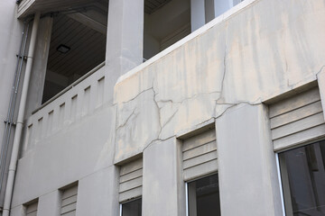 A close-up view of the concrete wall background shows the cracks of an old contemporary building.