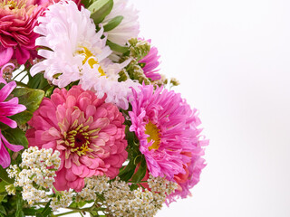 A bouquet of bright flowers on a light background.