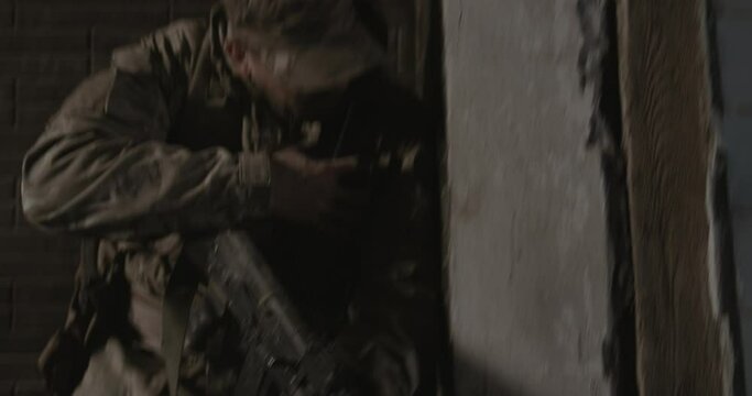 Soldier weapon fire, Conducting hostilities indoors. Concept: war, special forces, mercenaries, killer.