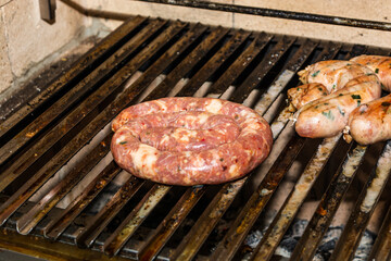 raw pork sausage grilling on grill