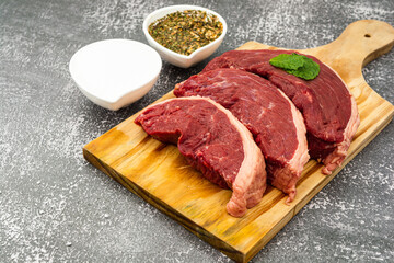 raw picanha steaks and seasonings