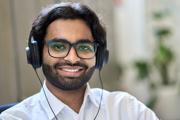 Smiling young indian business man office worker, male agent or customer support center manager...