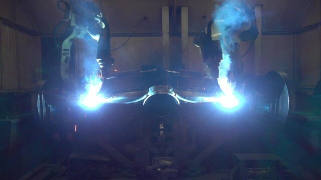 Team Robot welding movement Industrial automotive part in factory