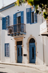 Fototapeta na wymiar Beautiful building with blue doors and windows in Larnaca, Cyprus