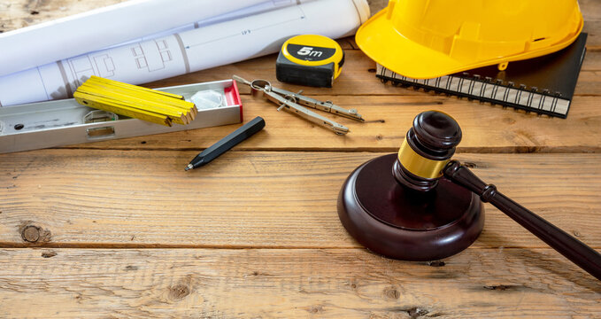 Construction and Labor law. Judge gavel and design tools on table