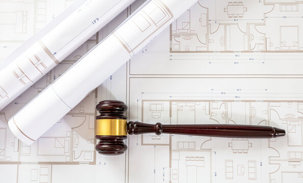 Labor, Construction law. Judge gavel on building blueprint plans, overhead