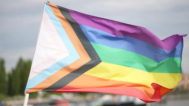 LGBTQ rainbow flag in a residential harbour area european city closeup