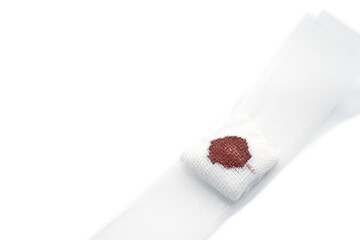 Gauze bandage with blood from accident on white background. with copy space