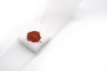 Gauze bandage with blood from accident on white background. with copy space