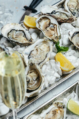 Oysters plate with lemon and champagne in restaurant. Oysters with lemon. vertical image. top view. place for text