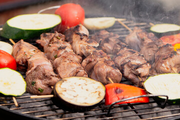 appetizing pork neck meat with vegetables is cooked in the grill, barbecue