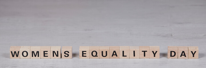 wooden blocks building the word womens equality day