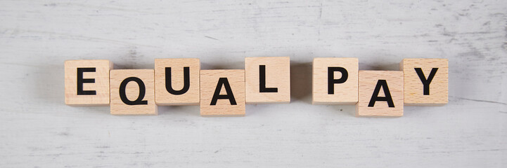 wooden blocks building the word equal pay