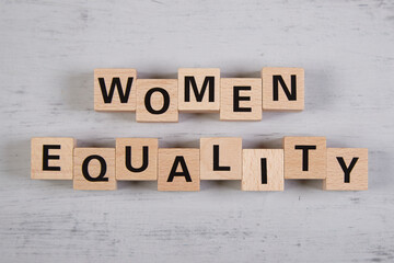 wooden blocks building the word women equality