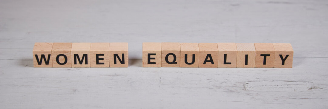 wooden blocks building the word women equality