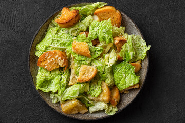 Classic Caesar salad with crisp homemade croutons, parmesan cheese and caesar dressing in a plate