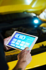 Hand of young engineer of maintenance service shop pointing at icon on tablet screen while visiting homepage of website