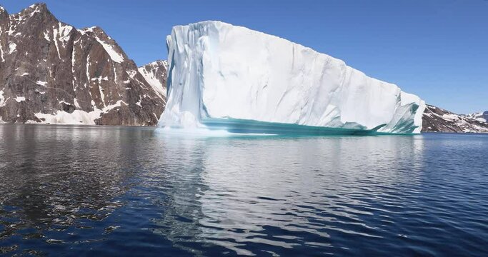 Melting Icebergs By The Coast Of Greenland, On A Beautiful Summer Day - General View Of Iceberg And Moutains From A Moving Boat - Greenland