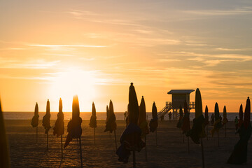 Sunset behind the parasols of Deauville in Normandy - obrazy, fototapety, plakaty