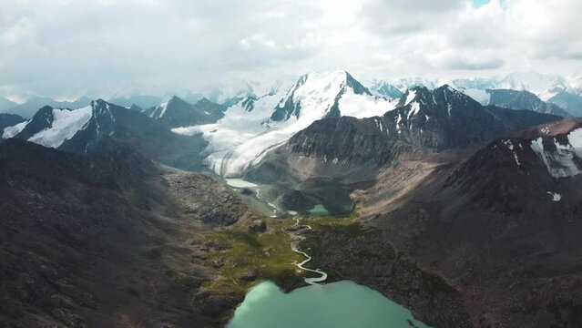 Ala-Kul Lake in Issyk Kul Region in Kyrgyzstan. Drone footage 4K. Mountains with big lake and epic clouds. 