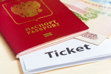 Foreign passport with ruble banknotes and electronic ticket.