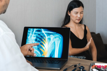Doctor showing a x-ray of pain in the ribs of a woman patient