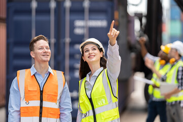 Caucasian two businessman and businesswoman working in container site.  Attractive engineer people discussion orders and product at warehouse logistic in cargo freight ship for import export in harbor