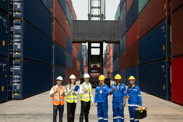 Portrait group of male and female worker working in container terminal. Attractive business man and woman laborer stand with confidence after process orders at warehouse logistic in cargo freight ship