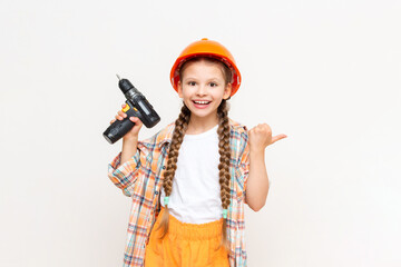 A little girl with a drill in her hands to show your advertisement on a white isolated background....