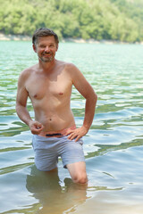 Fototapeta na wymiar man 50+ bathing in lake