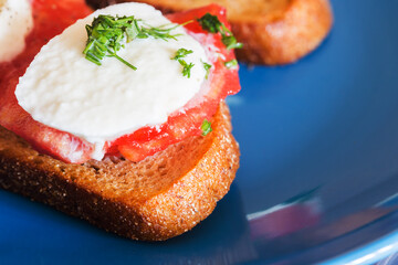 Bruschetta Caprese on a blue plate