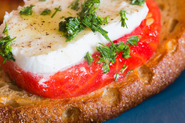 Bruschetta Caprese on a blue plate