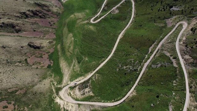 Teskey Torpock Pass (33 parrots) near to city Naryn and Son Kel lake in Kyrgyzstan. Epic slow movement from drone. Car ride on mountain road. 