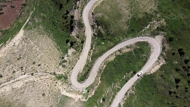 Teskey Torpock Pass (33 parrots) near to city Naryn and Son Kel lake in Kyrgyzstan. Epic slow movement from drone. Car ride on mountain road. 
