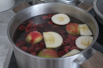 Compote of berries and apples in a saucepan.