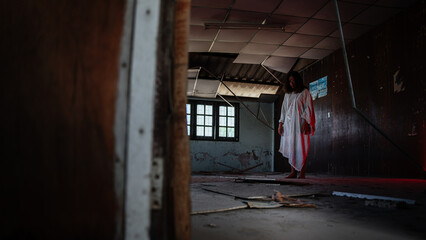 Naklejka na ściany i meble Ghost girl is in an abandoned house dressed in a scary white dress. Bloody lights and red eyes.