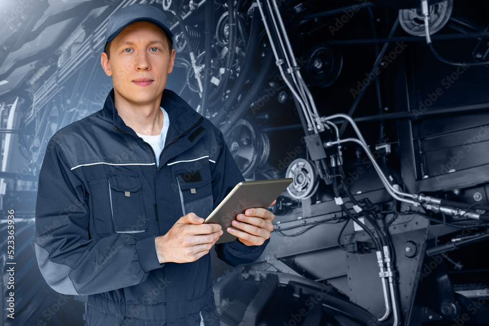 Aufkleber Serviceman with digital tablet on a background of the tractor with open hood