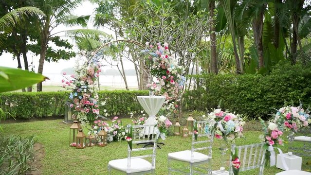 Decorated wedding arch chairs pastel ceremony garden.