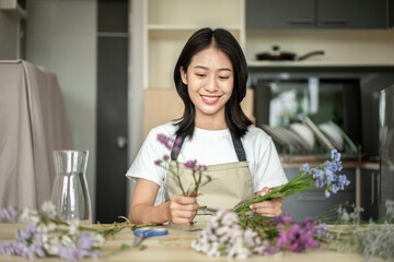 Weekend with her hobbies, Asian woman arranges a bouquet of flowers to decorate her home and beautify, Artificial flower arrangement, living room decoration ideas, Flowers bunch, Arts and crafts