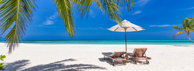 Beautiful tropical beach banner. Together, couple chairs coco palms travel tourism wide panorama holiday background. Amazing sunny beach landscape. Luxury island resort vacation. Tranquil sea sand sky
