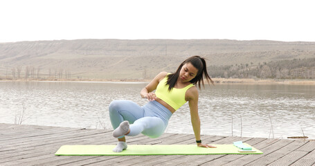 Fototapeta na wymiar Female Athlete Outdoor training Stretching of all muscle groups Fitness exercises