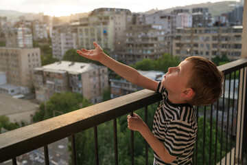 Unsupervised toddler climbing dangerous balcony railing Risky child behavior