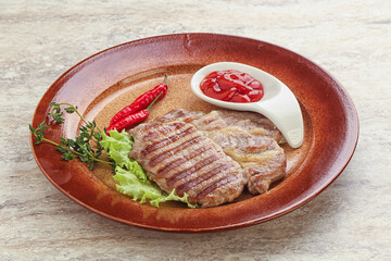 Grilled pork neck steak with ketchup