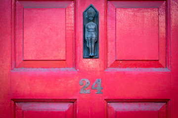House number 24 in red with Palace Guard
