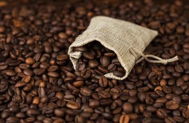 coffee beans from linen bag  on wooden table