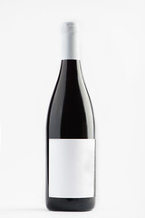 Red wine bottle isolated on a white background.